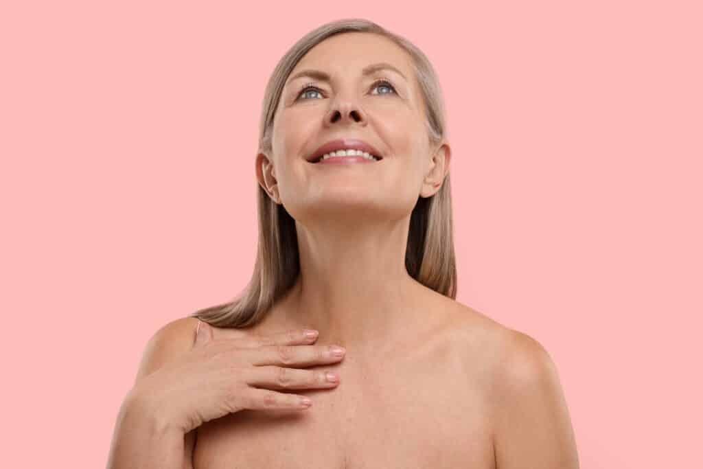 Woman lifting her chin showing the results of a neck lift in Palm Beach Gardens, FL