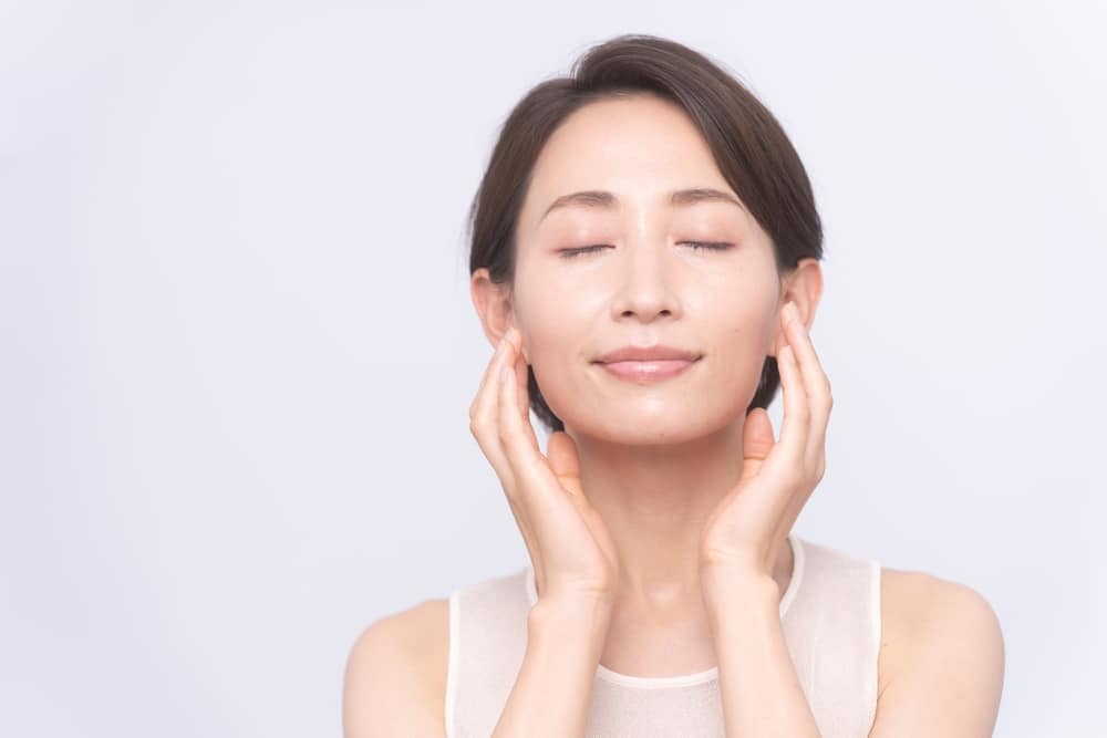 Woman with closed eyes representing natural-looking Asian eyelid surgery in Palm Beach Gardens.