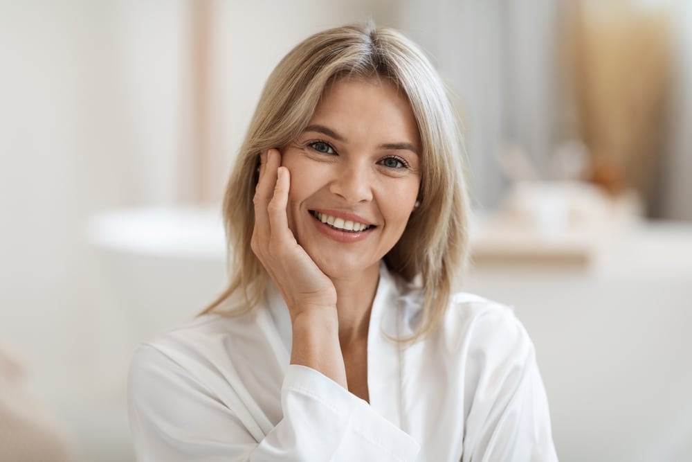 Smiling woman with smooth facial appearance representing natural-looking Botox results in Palm Beach Gardens.