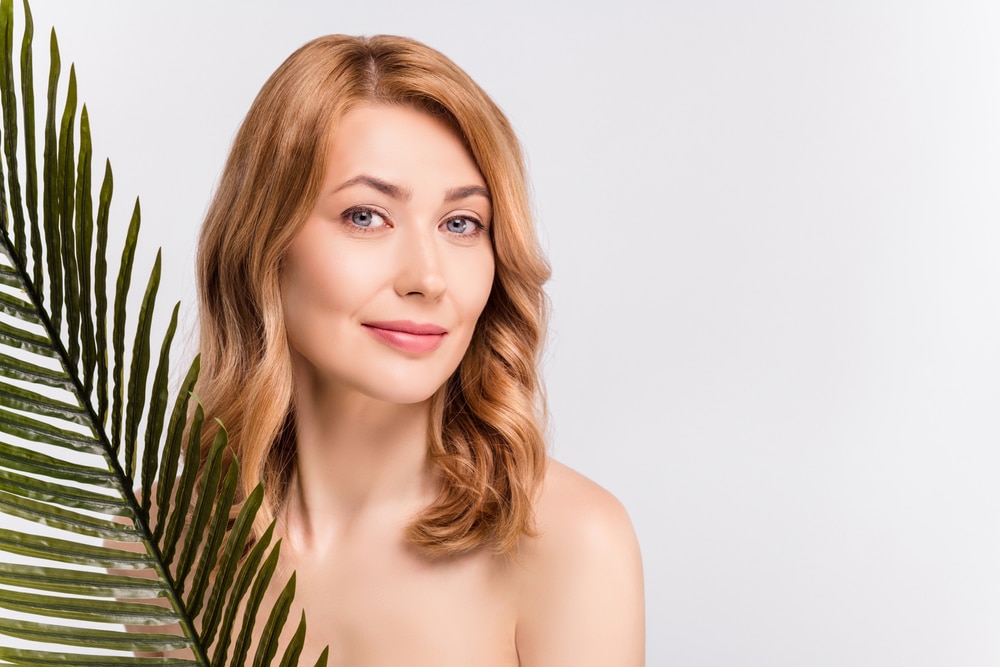 Woman with smooth facial contours representing facelift rejuvenation in Palm Beach Gardens.