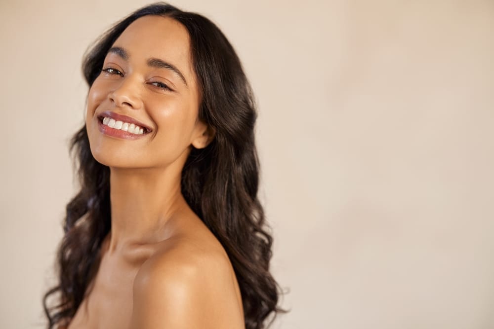 Smiling woman with smooth skin representing Juvederm facial rejuvenation in Palm Beach Gardens.
