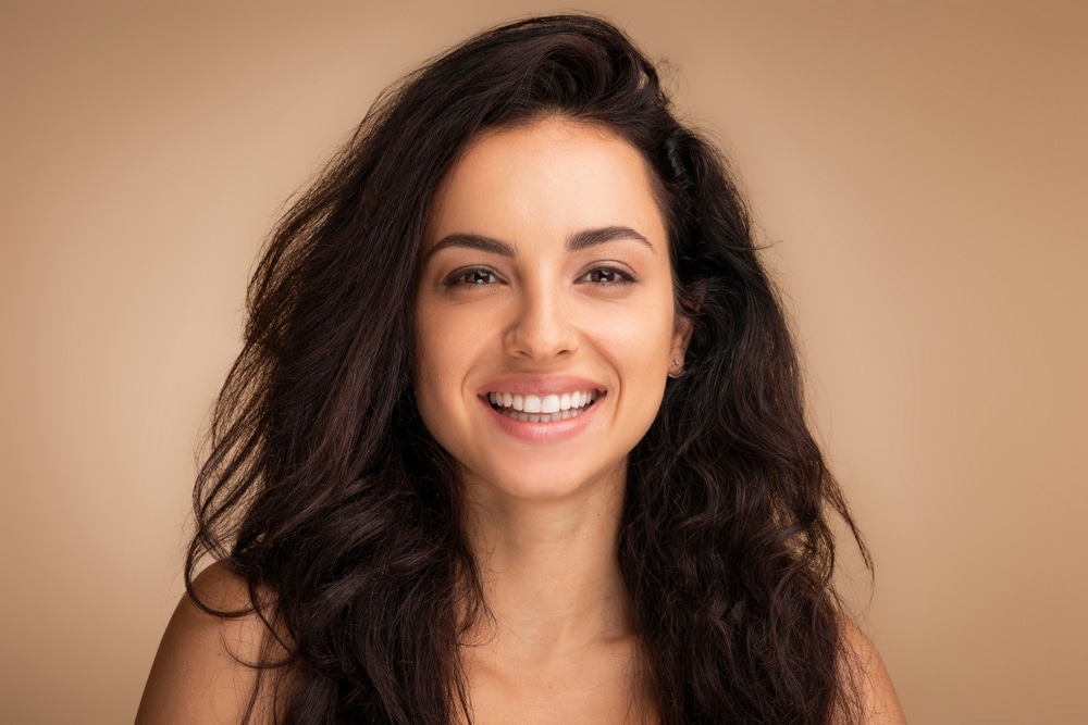 Smiling woman with smooth skin representing natural-looking Restylane facial rejuvenation in Palm Beach Gardens.