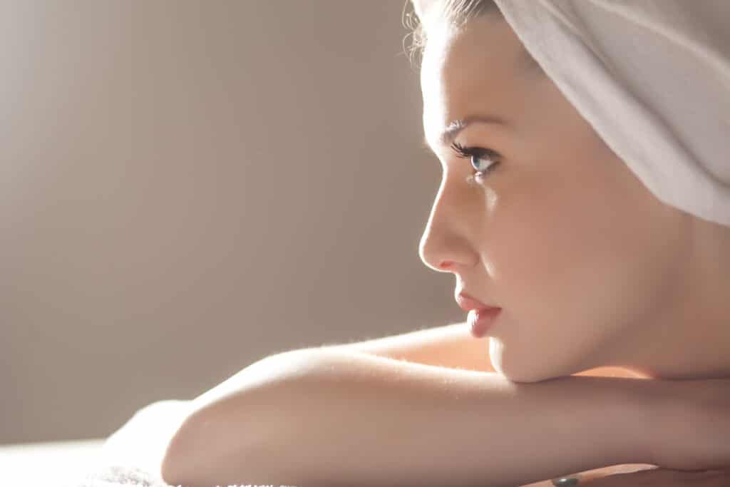 Woman in profile representing rhinoplasty for nose reshaping and improved facial balance in Palm Beach Gardens.