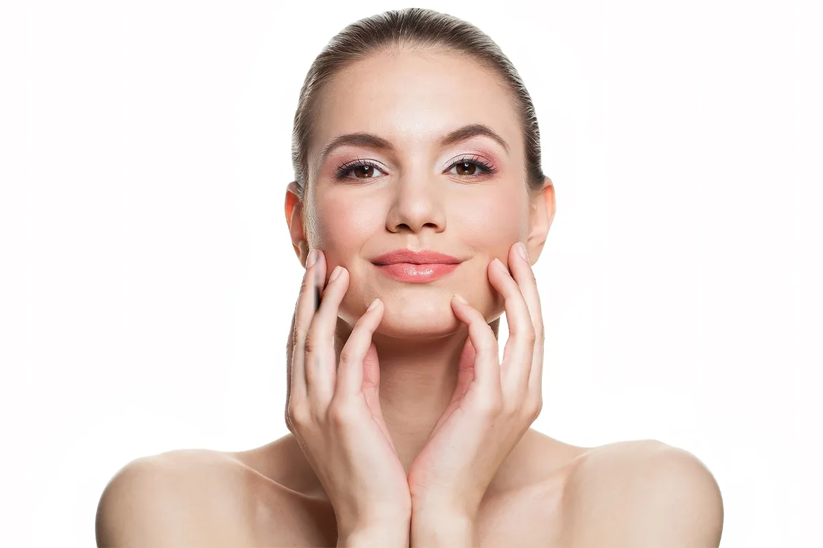 Woman touching her lower face and jawline.