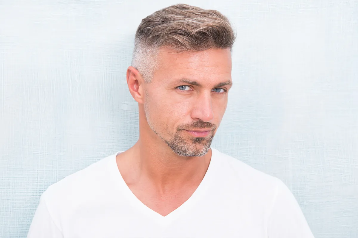 Mature man with short hair and a defined jawline.